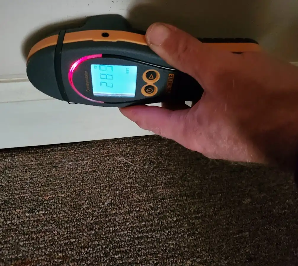Moisture detection at baseboard during Storm Damage Restoration in Fayetteville
